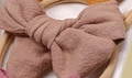 Soft nylon baby headband with a light brown-pink cotton bow and embroidered texture - Tan