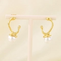 Detail of golden irregular streamline earrings with round white pearls on a display stand - Gold Streamlined (KE113305-KFC)