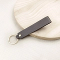 Minimalist dark coffee leather keychain with a metallic gold ring and rivet detail - No.5 Dark Grey
