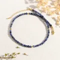 Detail of blue natural stone bead necklace with golden spacers and adjustable lobster clasp - Sodalite