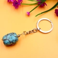 Handcrafted turquoise stone keychain with gold wire wrap and irregular crystal texture - Turquoise