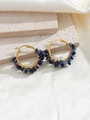 Detail of handmade gold hoop earrings wrapped with blue crushed natural stones - Blue