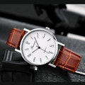 Macro shot of silver quartz watch with white dial and brown leather crocodile strap - White Dial Brown Strap with Numerals