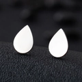 Macro shot of silver teardrop stud earrings on a textured black background surface - Water Drop / Silver