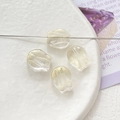 Macro shot of 4 sparkling shell-shaped beads for DIY jewelry making on a textured plate - Transparent Gold Glitter Shell (5# 10Pcs Price)