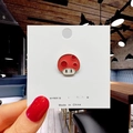Close-up of a cute red enamel mushroom pin with white dots on a white display card - 11*Red Mushroom Pin