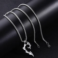 Close-up of silver box chain necklace with a jagged crescent pendant and inset rhinestone - Silver Magatama Pendant (Box Chain)
