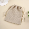 Detail of beige muslin cotton drawstring storage bag with natural crinkled texture - Light Khaki