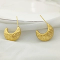Close-up of golden U-shaped earrings with intricate hollow embossed floral patterns - Hollow Carved Crescent Style (XL1464-57)
