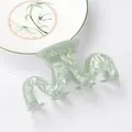 Light green acetate hair claw with pearlescent marble texture in a wavy curve design - Wavy Claw Clip / Mint Green Marble