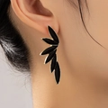 Elegant multi-layered gold-rimmed black leaf drop earrings shown on a model for casual wear - Black