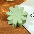 Matte light green daisy flower hair claw clip on a minimalist cork and book background - 4.8cm / Pale Green