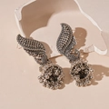 Detail of vintage peacock Jhumka earrings with ornate bell shape and silver bead tassels - Silver (Silver Pin)