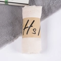 Creamy beige linen blend scarf roll with minimalist kraft paper band on a plush background - Off-white / One Size