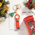 Detailed view of red Christmas nail clipper keychain with green silicone tree and pine cones - Christmas Tree