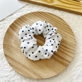 Polka dot white scrunchie hair tie on wooden tray with soft fabric texture and pleated design - White with Navy Dots