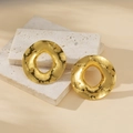 Irregular hammered gold round hoop earrings on a stone base with a minimalist aesthetic - Large Round Hammered / Gold