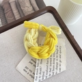 Braided high elasticity hair tie in yellow and light yellow tones on a wooden tray - Yellow