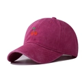 Detailed close-up of cherry embroidery on washed fuchsia cotton baseball cap - Rose Red