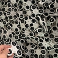 White three-arm fidget spinner with black weights in a bulk set with a hand holding one - Hole in Center 3-Arm Spinner No Packaging