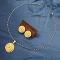 Close-up of golden necklace and earrings set with spiral pattern on blue fabric - E6107-13/Gold Round Spiral Pattern