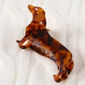 Close-up of tortoise shell dachshund hair claw clip on soft white knit fabric - Classic Tortoiseshell Dachshund (H379)
