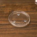 Transparent circular candle base tray with three-point support on wood background - Glass Tray