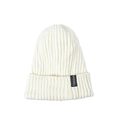 Detailed close-up of white ribbed knit beanie featuring a black Freedom brand label - White