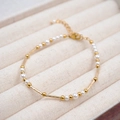 Elegant gold beaded bracelet with white pearls and adjustable lobster clasp closure - Bracelet