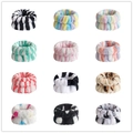 Set of coral fleece wristbands in various animal prints and striped patterns - Patterned Wristbands