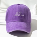 Close-up of purple washed cotton baseball cap with white In My Eras Era embroidery - Purple