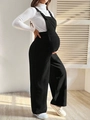 Dettaglio di una salopette premaman in velluto a coste nere con vita elastica regolabile - S / Nero