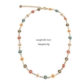 Detail showing colorful daisy flower charms on a gold stainless steel necklace chain - Daisy Necklace