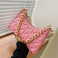 Detailed view of pink quilted underarm bag featuring a chunky gold chain strap - Pink