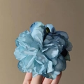 Blue gradient fabric flower hair clip held by hand with rich layered petals - Blue Peony Hair Claw
