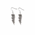 Macro detail of grey glitter acrylic lightning bolt earrings with metallic hooks - Transparent Grey