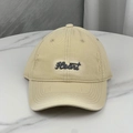 Detailed macro view of beige cotton baseball cap with Heart embroidery and distressed holes - Beige