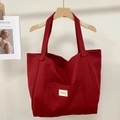 Detail of red striped canvas tote bag hanging on wooden hanger with side magazine prop - Cherry Red
