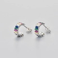 Macro shot of silver C-shaped earrings with colorful rectangular-cut zircon stones - Platinum / Multicolor Zirconia