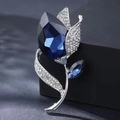 Elegant silver flower brooch with a deep blue crystal center and sparkling rhinestones - White Tulip Rhinestone