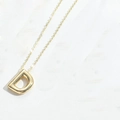 Minimalist gold letter D pendant necklace on a delicate chain for women - Letter D