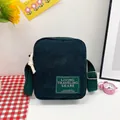 Dark green corduroy crossbody bag with adjustable canvas strap and square letter patch - Dark Green