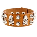 Macro view of brown punk leather bracelet with silver skull charms and metal rivets - Light Coffee Skull