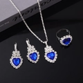 Silver jewelry set featuring blue heart crystals and small diamonds on black background - Necklace Earrings Ring Set / Dark Blue