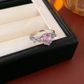 Detail shot of a silver crown ring with a pink round zircon and white side stones - Silver Pink Crown