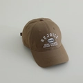 Detailed close-up of brown cotton baseball cap with white REJOICE embroidery - 52-54cm (3-8 Years) / Coffee