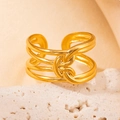 Golden titanium steel open ring featuring a twisted knot design on stone stand - Gold 131