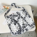 Macro detail of black and white paisley canvas tote bag with wide shoulder strap - 8 Retro White Base Paisley
