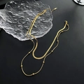 Minimalist double-layered gold necklace with flat snake chain and small bead design - Gold