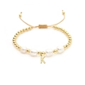 Detail of 18K gold bead bracelet with Baroque pearls and a hanging letter K pendant - Letter K